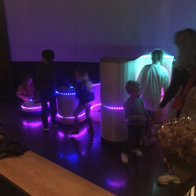 Children play with LED lights showing a sine wave